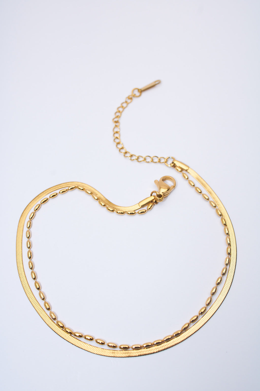 Pulsera doble capa serpiente + eslabón oval dorada