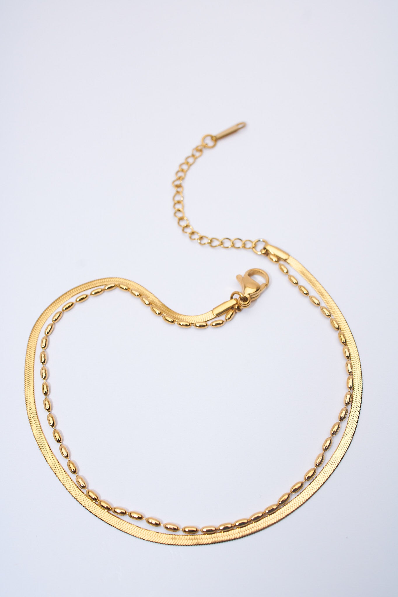 Pulsera doble capa serpiente + eslabón oval dorada