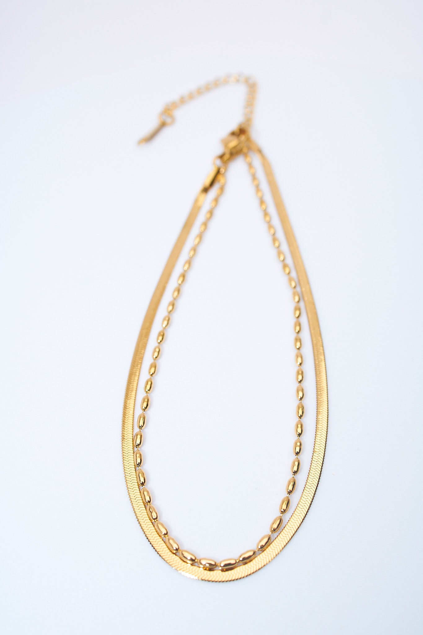 Pulsera doble capa serpiente + eslabón oval dorada