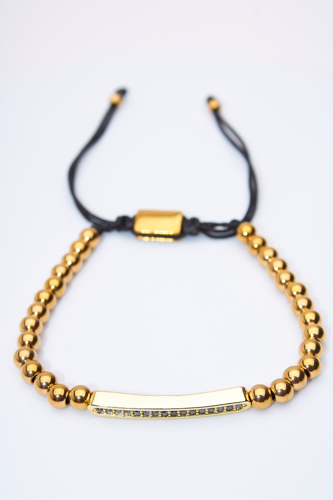 Pulsera ajustable de bolitas doradas con barra pavé