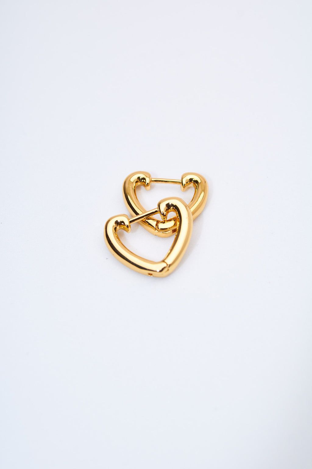 Aretes corazón hueco dorados — acabado pulido