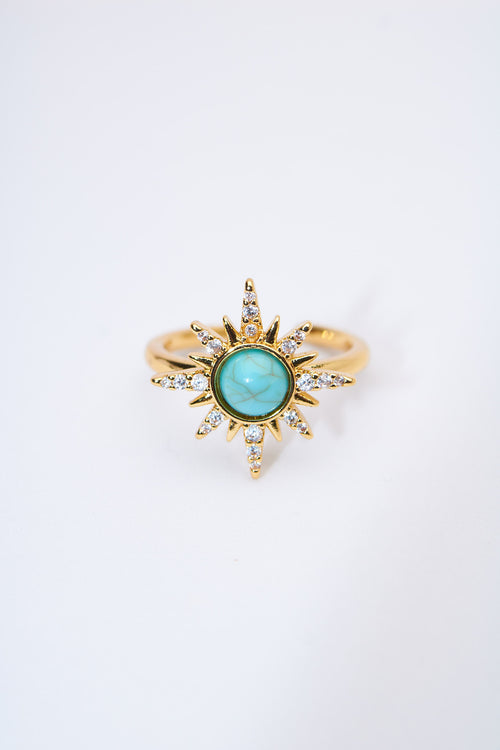Anillo sol radiante con piedra turquesa — baño dorado