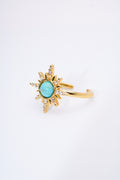 Anillo sol radiante con piedra turquesa — baño dorado
