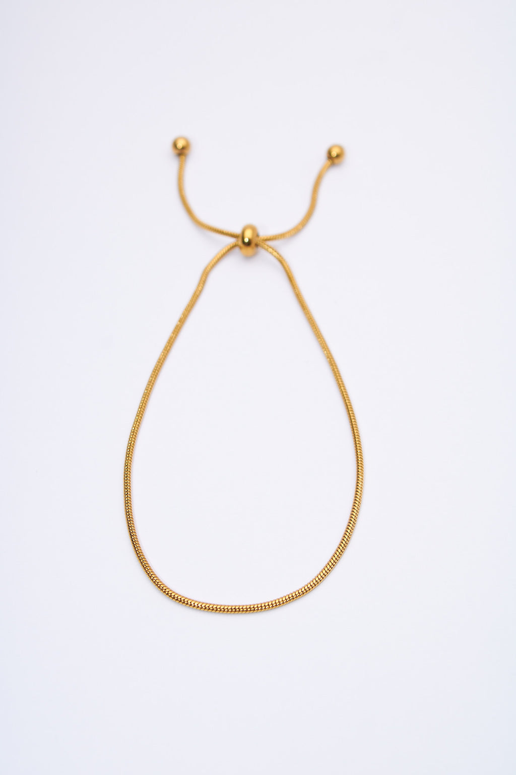 Pulsera ajustable serpiente dorada — deslizador y terminales esféricos